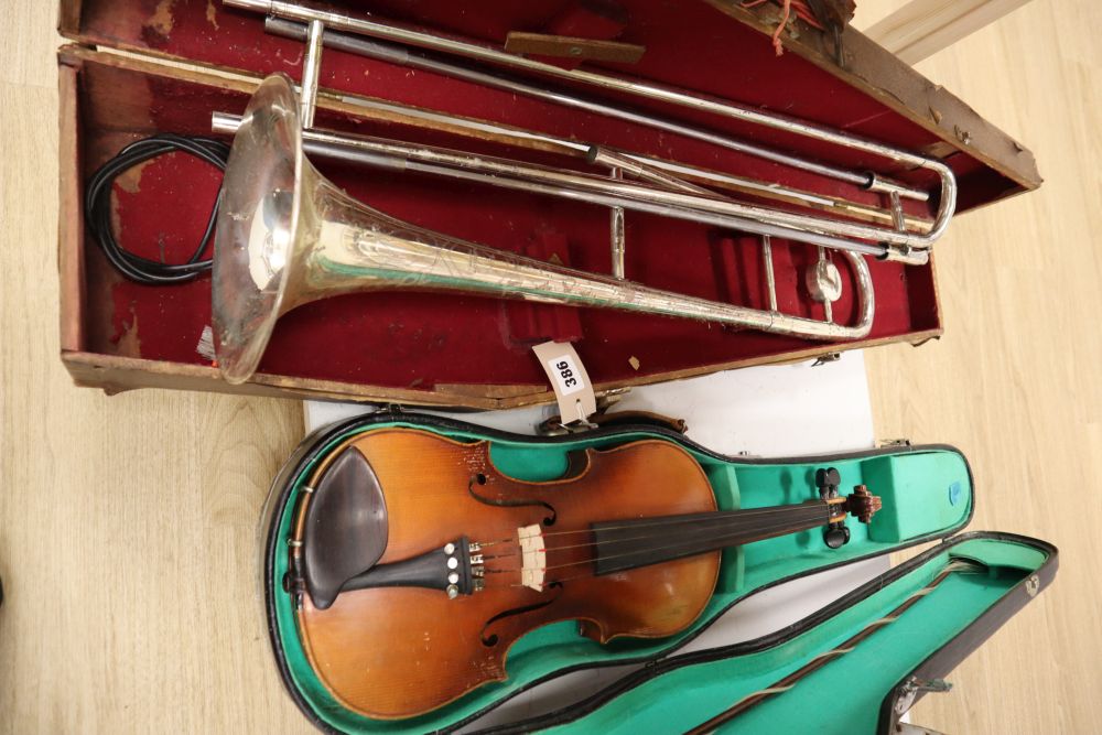 A violin, with 35.5cm back, with bow and some accessories, in case, together with Parrot trombone, cased